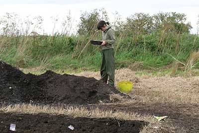 Archaeologist next to a spoil heap